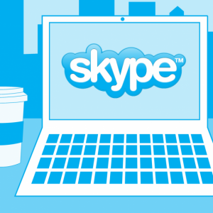 Skype logo on laptop with coffee